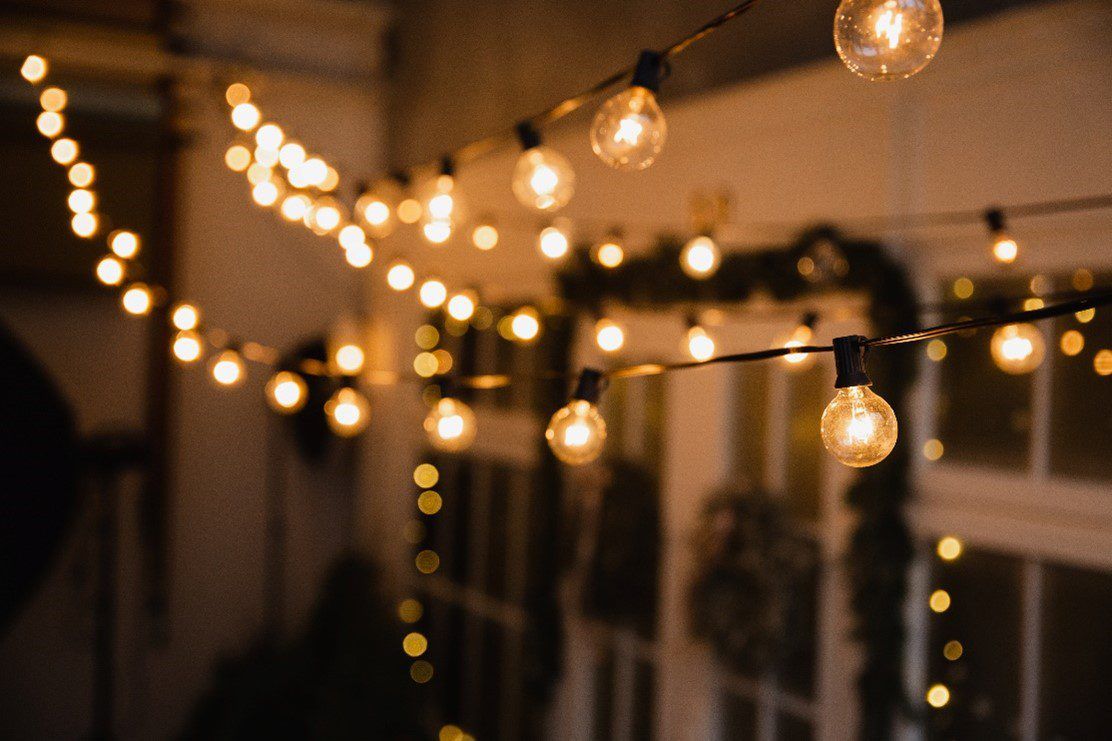 String lights hung up outside near a window